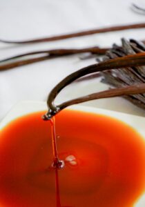 a small white plate with a red sauce on it